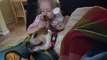 Little girl uses dog's ears as baby wipes
