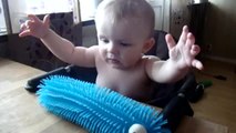 Baby scares himself by touching toy