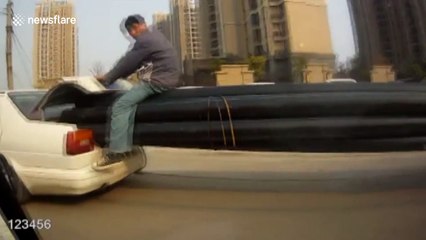 Man rides 20-metre-long plastic pipes poking out of car