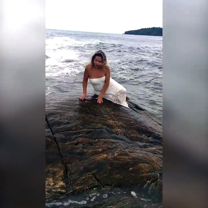 The Awkward Mermaid Sitting On A Rock By The Sea For Some Photo's posing What Can Possibly Go Wrong