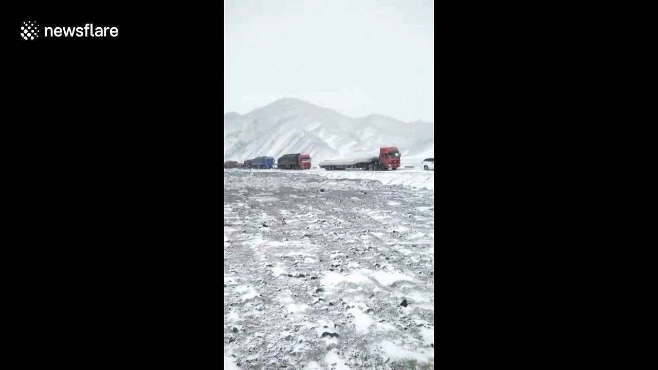 Snow disrupts traffic and traps 200 vehicles on road in northern China