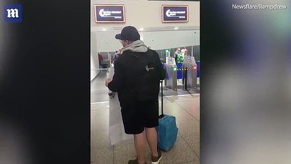 Stag-do reveller hands over giant boarding pass at airport