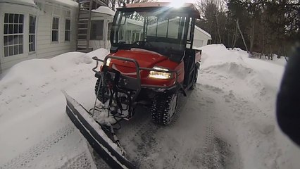 how to Kobota rtv 900 plowing snow.