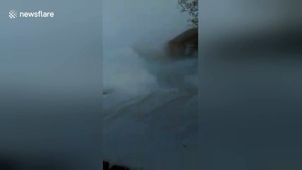 Car buried in snow during blizzard in Canada