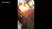 Flaming car ignites gas cylinders causing huge explosion