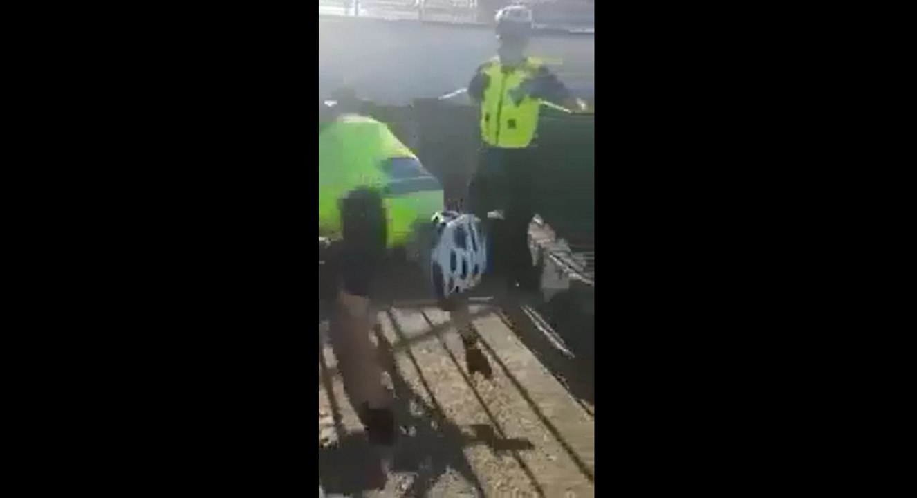 Un policier tente de faire une demonstration de vélo à des jeunes.