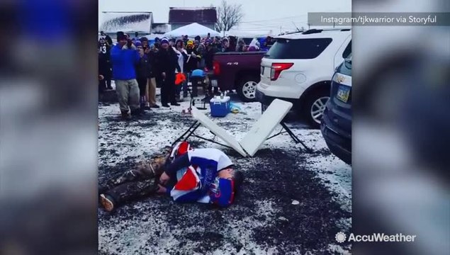 Football fan leaps from snowy car onto table, snaps leg