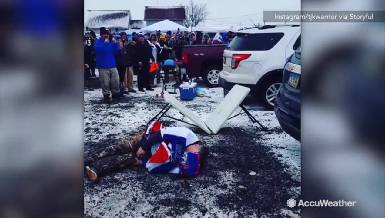 Football fan leaps from snowy car onto table, s...