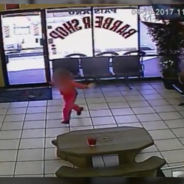 Stray bullets narrowly miss child in barbershop. [Mic Archives]