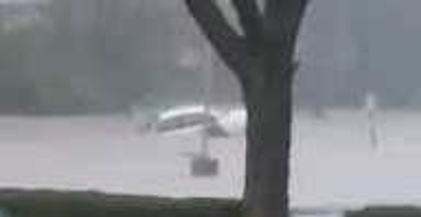 Floodwaters Submerge Car in Cincinnati Parking Lot