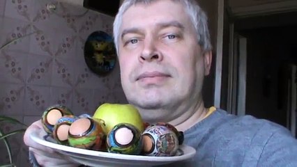 Пасхальные яйца на тарелке и зеленое яблоко