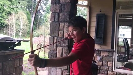 Boy pulls his tooth out with a bow and arrow