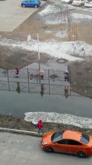 Children Scale Fence to Avoid Flooding to Get to School