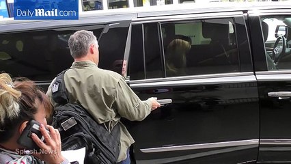 Reese Witherspoon arrives at LAX in chic black sweater -