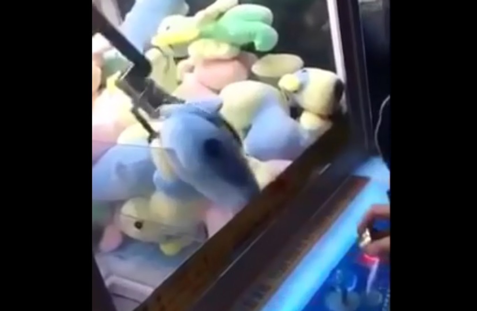 Un homme jouant sur une machine à pince gagne une peluche à laquelle il  ne s'attendait pas (vidéo)