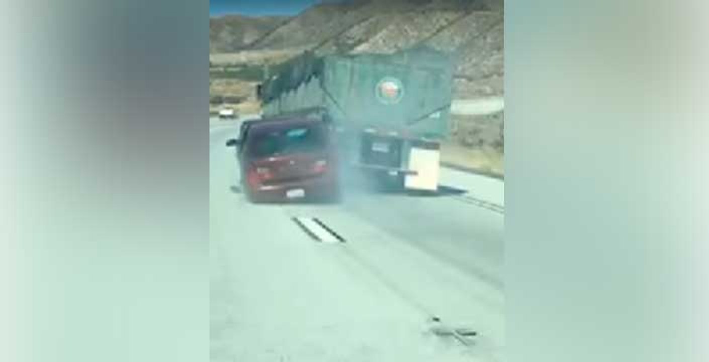 Truck driver doesnt stop even with a car stuck to its end
