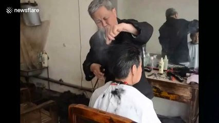 Chinese barber straightens hair with hot tongs