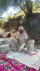 A man making very big Bread in pakistan