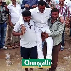 Odisha MLA lifted by supporters so his shoes don’t get wet