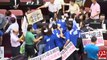 Taiwan lawmakers grab each other's throats in parliament