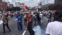 Protesters Toss Away Tear Gas Canisters Thrown by Venezuelan Police