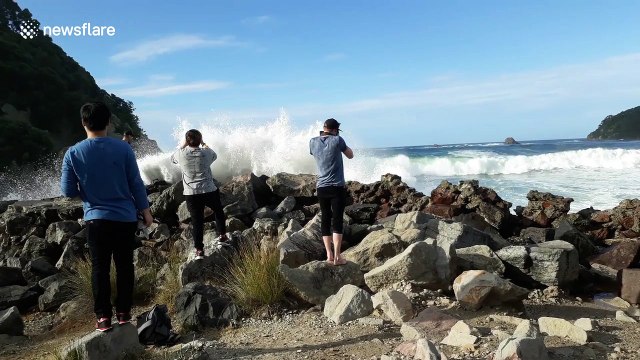 Beach goers get soaked by large wave