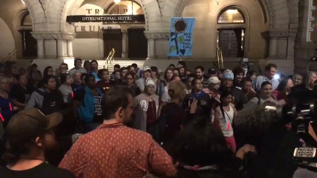 Environmental activists block intersection near Trump hotel in Washington DC