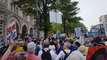 Demonstrators March in Front of Trump Hotel in Washington