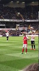 Mesut Ozil rubbing his Arsenal badge in front of abusing Spurs fans