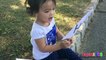 Toddler learning ABC Alphabets on a White Flags _ Fun outdoors park-nQaI