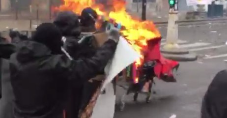 Protesters Push Flaming Cart Towards Police During May Day Clashes in Paris