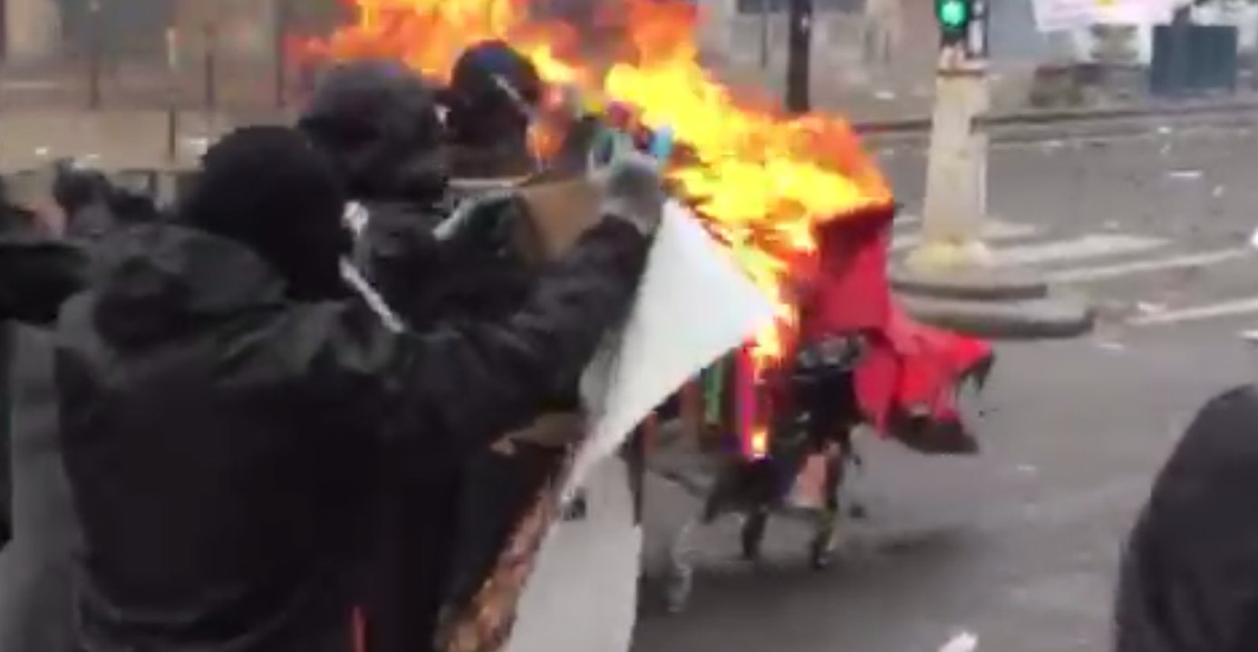 Protesters Push Flaming Cart Towards Police During May Day Clashes in Paris