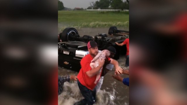 Texan 'hero' motorists rescue babies from overturned car in storm flood
