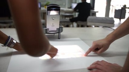 Transform any surface into a touchscreen computer with this projector