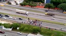 Car drives through crowd of people on highway