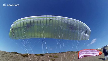 Freak gust of wind throws paraglider pilot