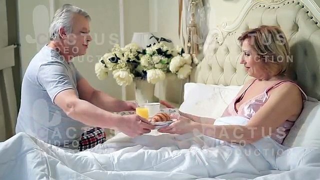 Top kissing scenes of Couple lounging in bed after awaking cuddling at midnight