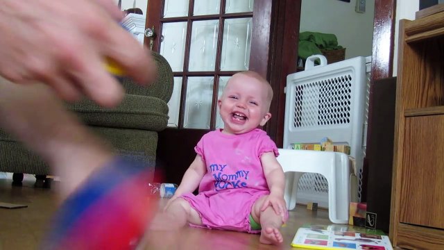 Funny Baby Laughs Uncontrollably and Tips Over
