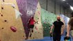 Climber scales indoor wall with no hands