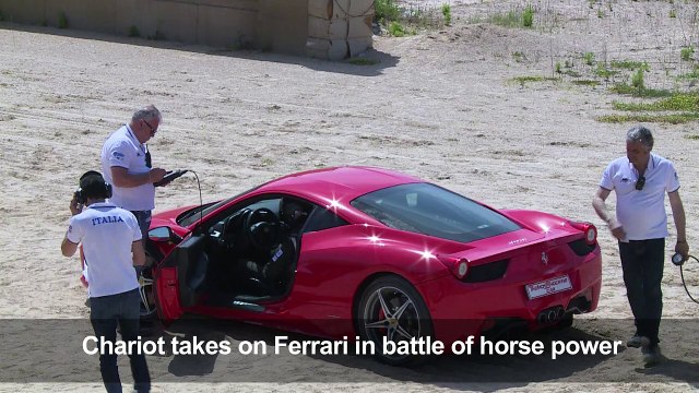 Ferrari driver competes with Roman chariot drawn by horses