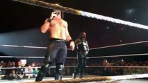 Seth Rollins stands with Roman Reigns in Lille, France