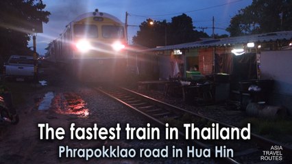 The fastest train in Thailand passing back of the houses in Phrapokklao road in Hua Hin