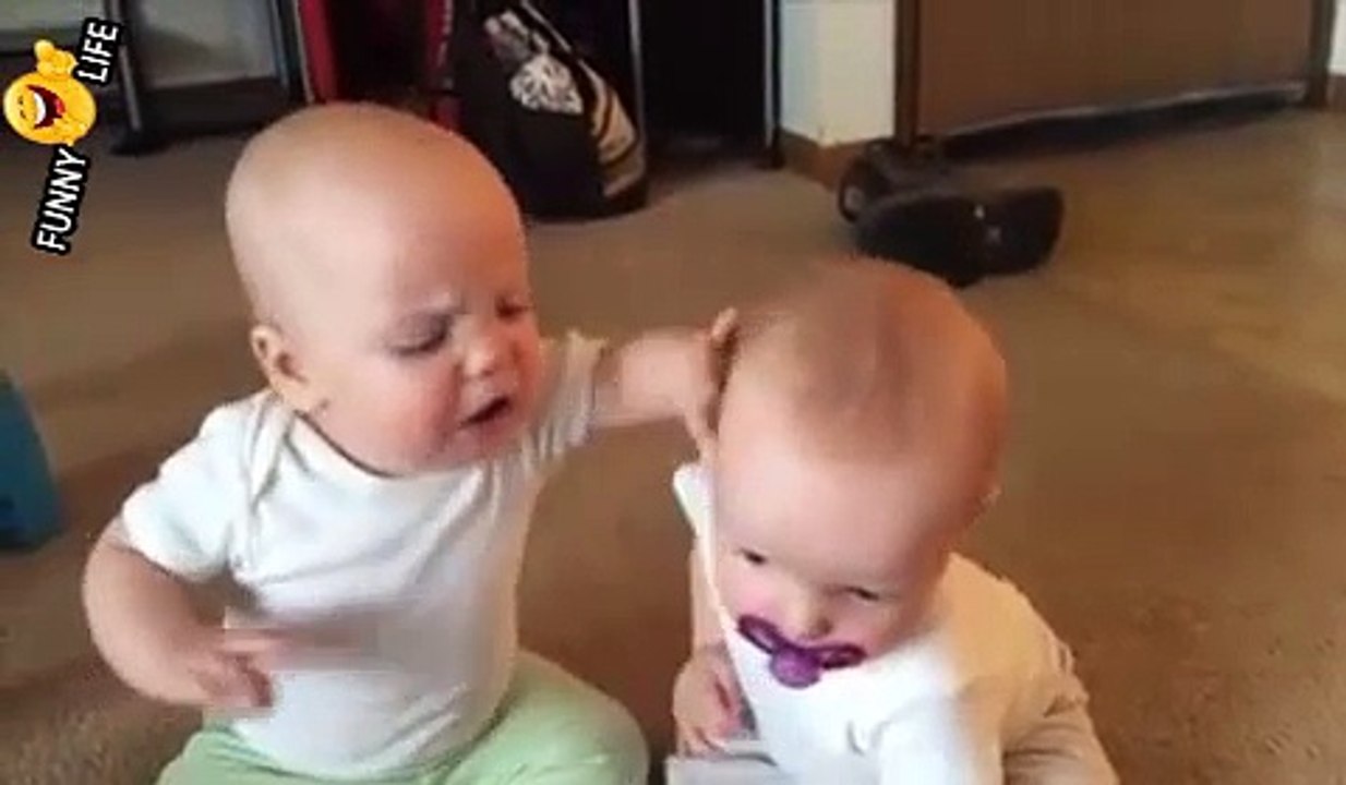 Twin baby girls fight over pacifier