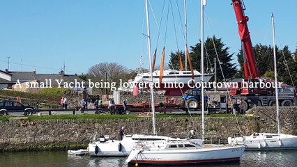 A small yacht being lowered into Courtown harbour