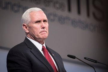 Graduates march out of Mike Pence's speech