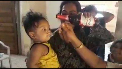 Mother feeding food to their child funny reaction