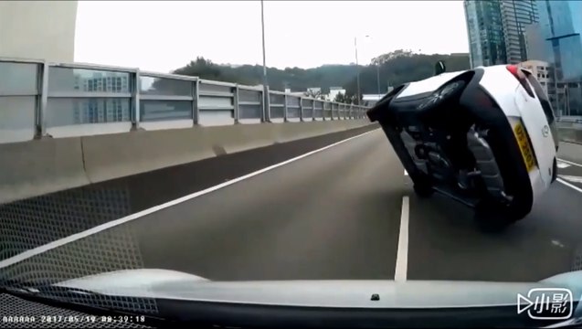 Une voiture sur 2 roues qui double sur l'autoroute.