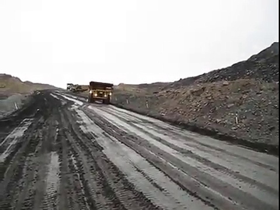 Operator negotiates slippery haul road - Stockton New Zealand
