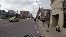 Motorcyclist turns right on red when we have right of way, cuts off cyclist in b