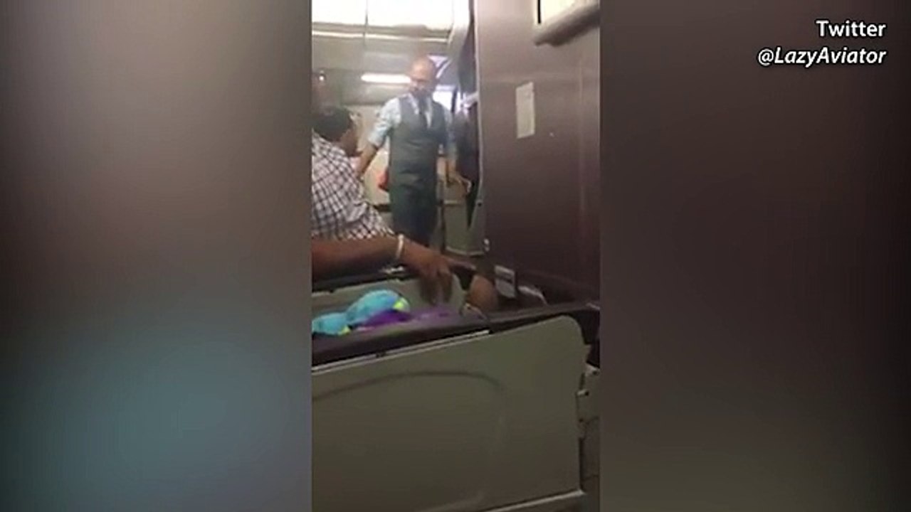 Armed police escort the alleged attempted hijacker off the plan